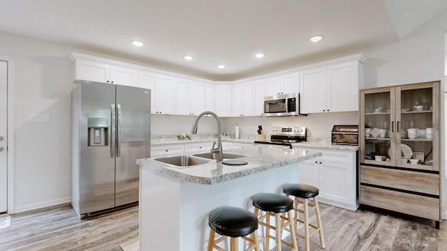 341 Holly Grove Rd, Lewisburg, TN 37091 - kitchen featuring stainless steel appliances, light wood-type flooring, white cabinetry, an island with sink, and recessed lighting