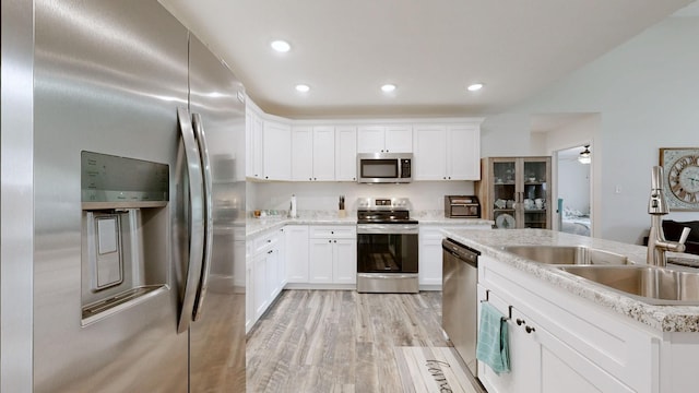 341 Holly Grove Rd, Lewisburg, TN 37091 - kitchen with stainless steel appliances, light wood-type flooring, white cabinetry, light countertops, and recessed lighting