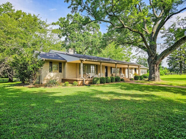 4623 Lebanon Rd, Murfreesboro, TN 37129 - ranch-style house featuring a front yard, covered porch, a chimney, and brick siding