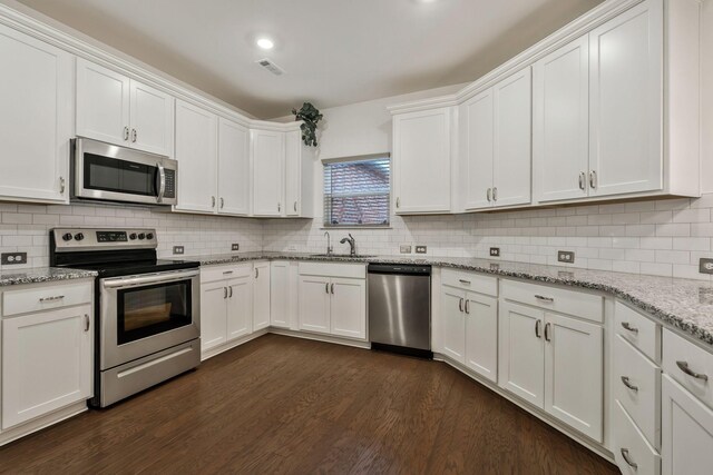 2326 Laurelstone Dr, Murfreesboro, TN 37130 - kitchen with stainless steel appliances, white cabinetry, tasteful backsplash, and dark wood-type flooring