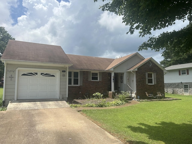 217 Millcreek Dr, Loretto, TN 38469 - view of front of home featuring concrete driveway, a garage, a front yard, brick siding, and a shingled roof