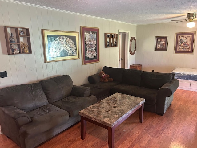 217 Millcreek Dr, Loretto, TN 38469 - living room featuring wood finished floors, a textured ceiling, ornamental molding, and a ceiling fan