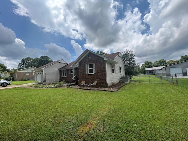 217 Millcreek Dr, Loretto, TN 38469 - back of house with a garage, brick siding, driveway, and a gate
