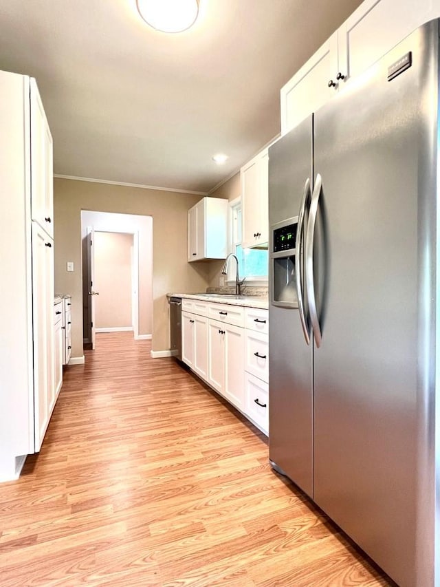210 Roney Dr, Hopkinsville, KY 42240 - kitchen featuring stainless steel appliances, light wood-style floors, white cabinetry, and light countertops