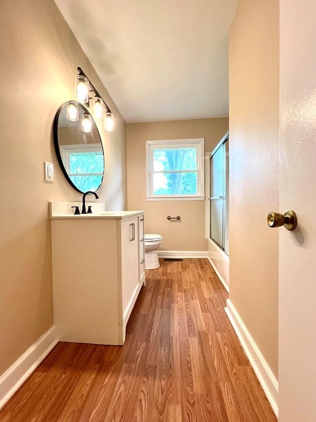 210 Roney Dr, Hopkinsville, KY 42240 - full bath featuring vanity, wood finished floors, and shower / bath combination with glass door