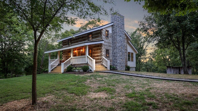8014 Shoals Branch Rd, Primm Springs, TN 38476 - rear view of property with covered porch, a chimney, a yard, stairs, and log siding