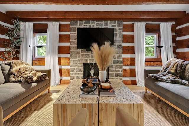 8014 Shoals Branch Rd, Primm Springs, TN 38476 - living room featuring beamed ceiling, wood walls, light wood-style floors, and a fireplace