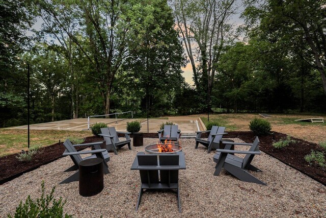 8014 Shoals Branch Rd, Primm Springs, TN 38476 - patio terrace at dusk featuring an outdoor fire pit and view of scattered trees
