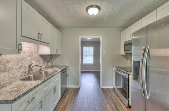212 Towbridge Dr, Murfreesboro, TN 37129 - kitchen featuring stainless steel appliances, dark wood finished floors, backsplash, white cabinetry, and a textured ceiling