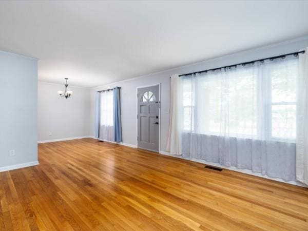 1905 Highland Ave, Columbia, TN 38401 - unfurnished living room featuring a chandelier, ornamental molding, and wood finished floors
