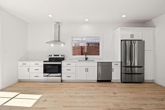 1905 Highland Ave, Columbia, TN 38401 - kitchen with appliances with stainless steel finishes, wall chimney range hood, white cabinetry, light wood-style floors, and recessed lighting