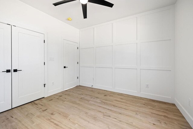 1905 Highland Ave, Columbia, TN 38401 - unfurnished bedroom featuring light wood-type flooring, a decorative wall, and a ceiling fan
