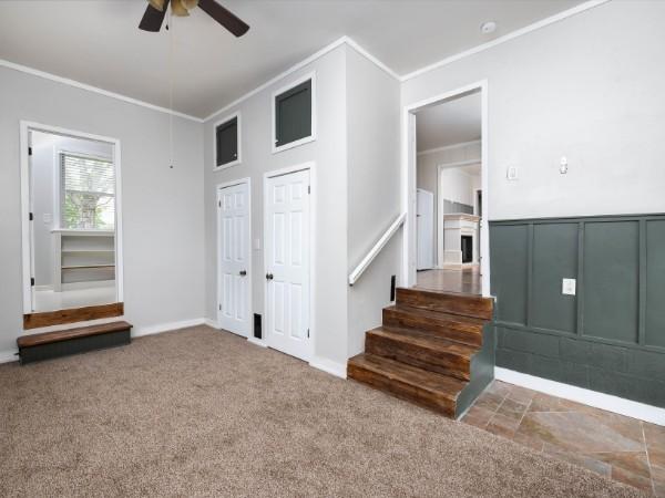1905 Highland Ave, Columbia, TN 38401 - carpeted spare room featuring crown molding, a ceiling fan, and stairway