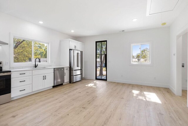 1905 Highland Ave, Columbia, TN 38401 - kitchen with appliances with stainless steel finishes, light wood-style flooring, light countertops, white cabinetry, and recessed lighting