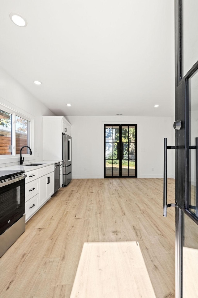 1905 Highland Ave, Columbia, TN 38401 - kitchen featuring stainless steel appliances, white cabinetry, light wood-type flooring, recessed lighting, and light countertops