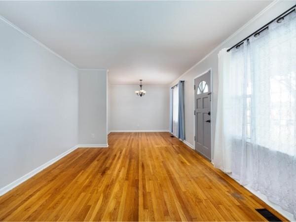 1905 Highland Ave, Columbia, TN 38401 - unfurnished room featuring crown molding, a chandelier, and wood finished floors
