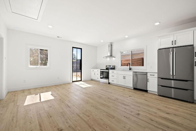 1905 Highland Ave, Columbia, TN 38401 - kitchen with appliances with stainless steel finishes, wall chimney range hood, white cabinetry, light wood-type flooring, and recessed lighting