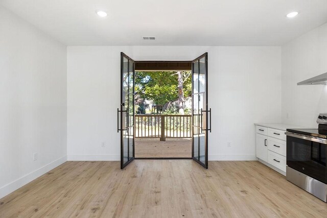 1905 Highland Ave, Columbia, TN 38401 - kitchen featuring stainless steel electric stove, light wood finished floors, white cabinetry, recessed lighting, and light countertops