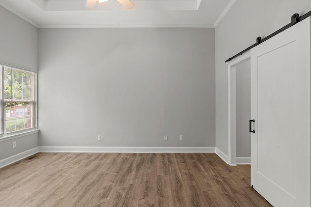 231 Green Harbor Rd Unit 59, Old Hickory, TN 37138 - unfurnished bedroom with a barn door, wood finished floors, ornamental molding, and a ceiling fan
