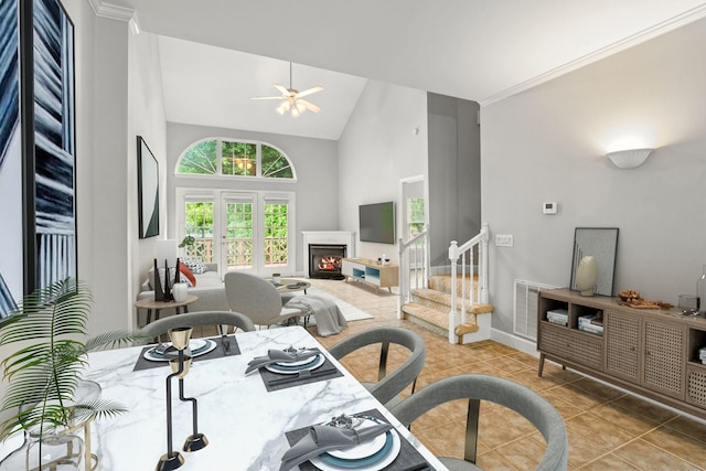 231 Green Harbor Rd Unit 59, Old Hickory, TN 37138 - dining space featuring light tile patterned floors, high vaulted ceiling, ceiling fan, a lit fireplace, and stairs
