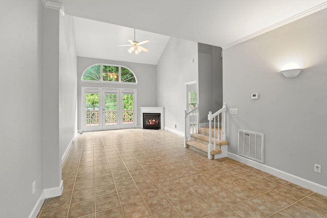231 Green Harbor Rd Unit 59, Old Hickory, TN 37138 - unfurnished living room featuring high vaulted ceiling, plenty of natural light, a ceiling fan, a lit fireplace, and stairs
