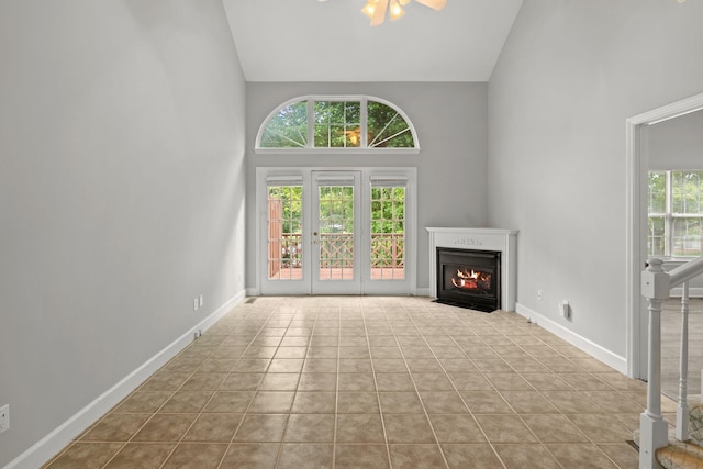 231 Green Harbor Rd Unit 59, Old Hickory, TN 37138 - unfurnished living room featuring high vaulted ceiling, a fireplace with flush hearth, and tile patterned floors