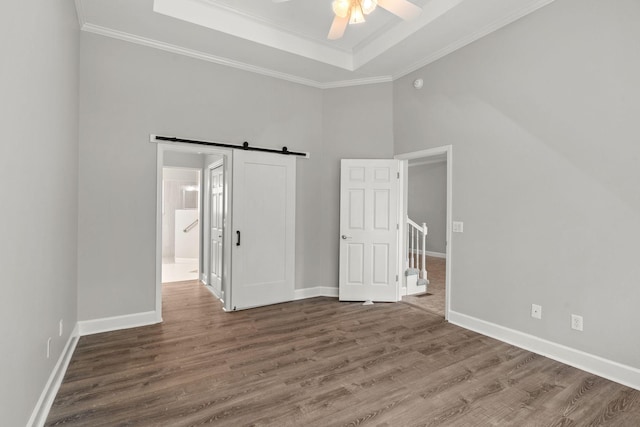 231 Green Harbor Rd Unit 59, Old Hickory, TN 37138 - unfurnished bedroom with a raised ceiling, wood finished floors, a barn door, ornamental molding, and ensuite bath