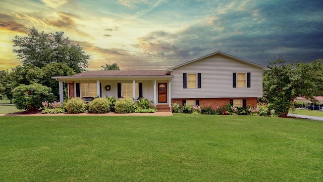 1335 Chippendale Cir, Columbia, TN 38401 - tri-level home with a lawn, covered porch, and brick siding