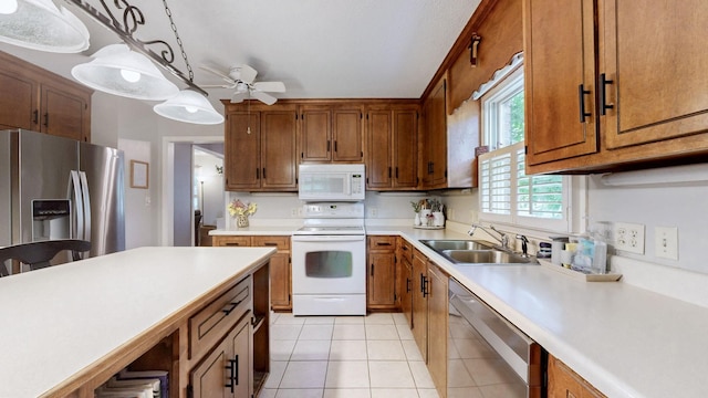 1335 Chippendale Cir, Columbia, TN 38401 - kitchen featuring stainless steel appliances, a ceiling fan, light countertops, and brown cabinetry