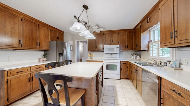 1335 Chippendale Cir, Columbia, TN 38401 - kitchen featuring stainless steel appliances, brown cabinetry, and light countertops