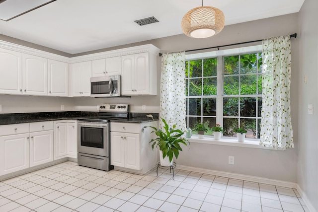 2910 Churchill Ln, Thompsons Station, TN 37179 - kitchen featuring stainless steel appliances, white cabinetry, plenty of natural light, and light tile patterned flooring