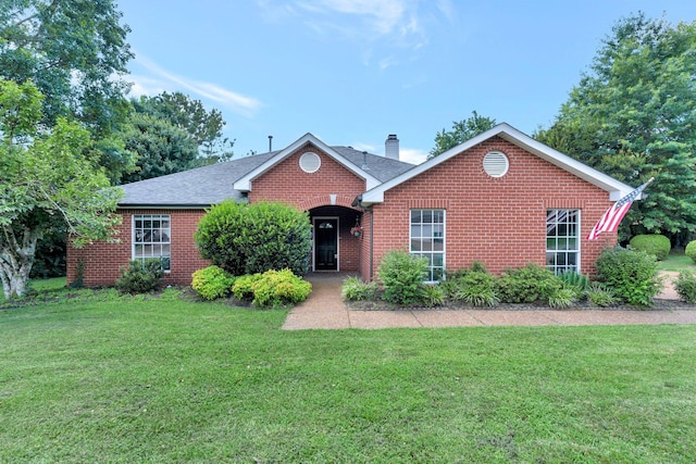 2910 Churchill Ln, Thompsons Station, TN 37179 - ranch-style home with brick siding, a chimney, a front yard, and a shingled roof