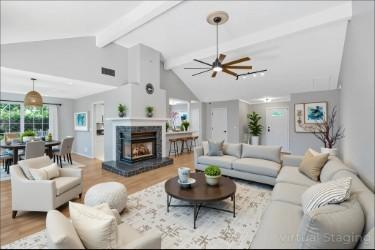 2910 Churchill Ln, Thompsons Station, TN 37179 - living room featuring beamed ceiling, a ceiling fan, wood finished floors, a fireplace with raised hearth, and high vaulted ceiling