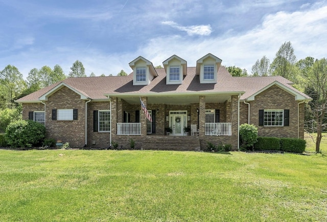 2600 Little Bartons Creek Rd, Cumberland Furnace, TN 37051 - cape cod house with covered porch, brick siding, and a front yard