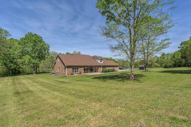 2600 Little Bartons Creek Rd, Cumberland Furnace, TN 37051 - view of grassy yard featuring a storage shed and a patio area