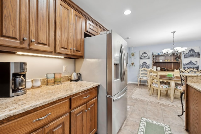 1550 Beech Bottom Rd, Watertown, TN 37184 - kitchen with stainless steel refrigerator with ice dispenser, brown cabinetry, light tile patterned floors, a chandelier, and recessed lighting