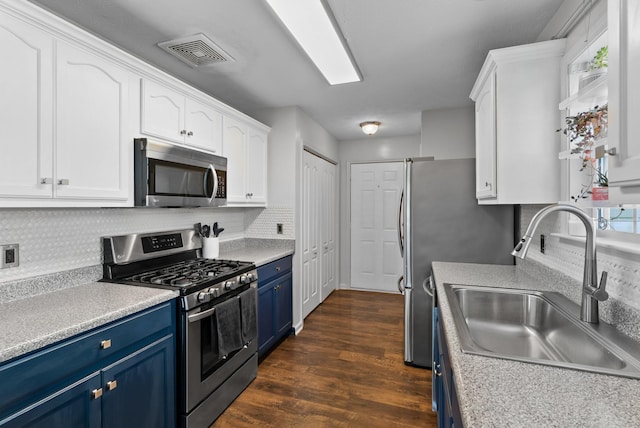 1620 Baucom Dr, Columbia, TN 38401 - kitchen featuring stainless steel appliances, blue cabinets, white cabinetry, decorative backsplash, and dark wood-type flooring