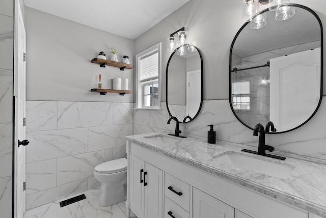 1620 Baucom Dr, Columbia, TN 38401 - bathroom featuring tile walls, marble finish floors, double vanity, wainscoting, and a shower
