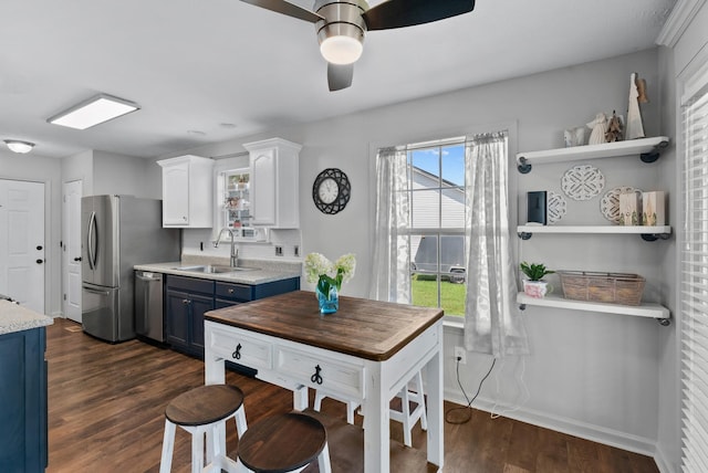 1620 Baucom Dr, Columbia, TN 38401 - kitchen featuring blue cabinets, stainless steel appliances, dark wood-style floors, ceiling fan, and plenty of natural light