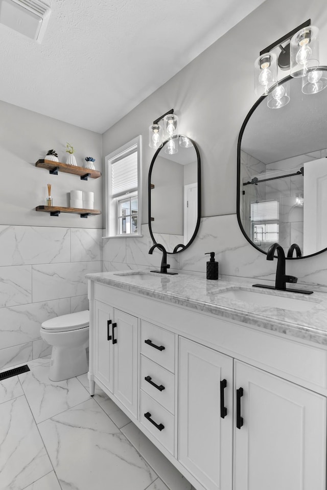 1620 Baucom Dr, Columbia, TN 38401 - full bath with tile walls, double vanity, a marble finish shower, marble look tile flooring, and a textured ceiling