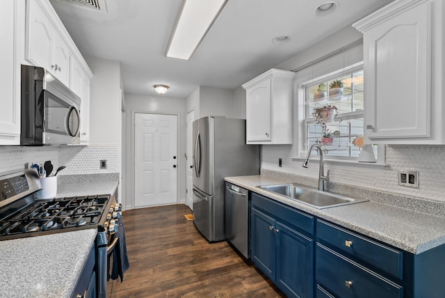 1620 Baucom Dr, Columbia, TN 38401 - kitchen with stainless steel appliances, blue cabinets, and white cabinetry