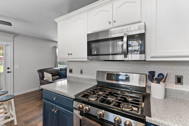 1620 Baucom Dr, Columbia, TN 38401 - kitchen featuring appliances with stainless steel finishes, blue cabinetry, decorative backsplash, white cabinetry, and dark wood-style floors