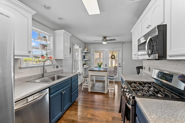 1620 Baucom Dr, Columbia, TN 38401 - kitchen featuring stainless steel appliances, blue cabinets, and white cabinets