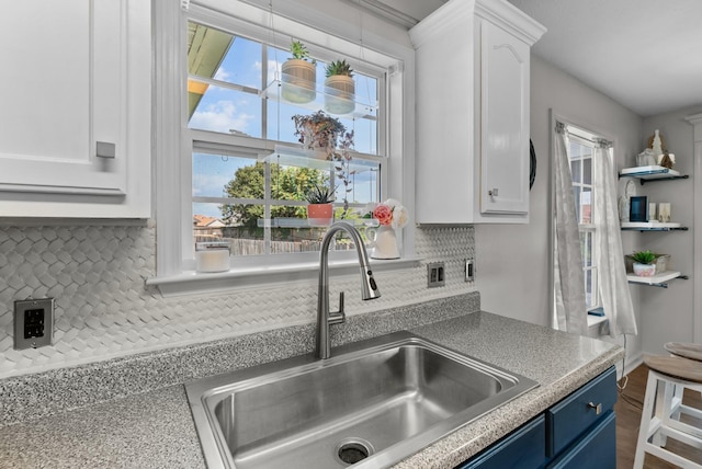 1620 Baucom Dr, Columbia, TN 38401 - kitchen featuring blue cabinets, white cabinets, and decorative backsplash