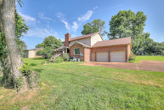 2010 Hartland Rd, Franklin, TN 37069 - view of front of home featuring brick siding, a chimney, a front lawn, and a garage