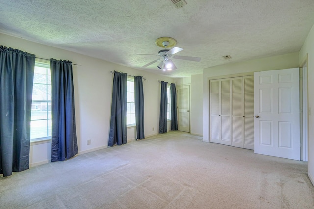 2010 Hartland Rd, Franklin, TN 37069 - unfurnished bedroom with carpet, a textured ceiling, a ceiling fan, and two closets