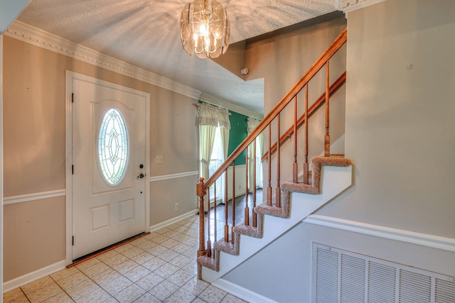2010 Hartland Rd, Franklin, TN 37069 - foyer entrance featuring light tile patterned floors, stairs, a chandelier, and crown molding