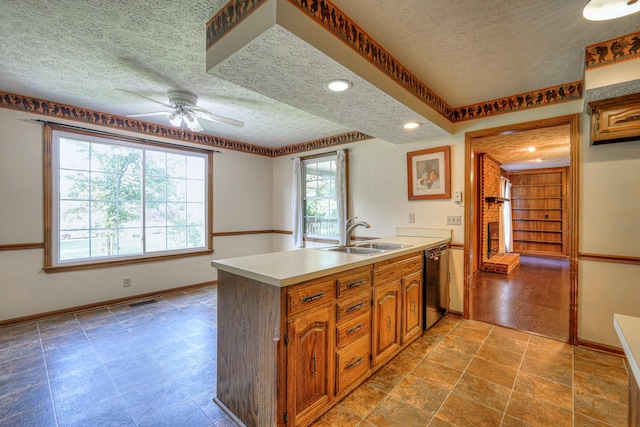 2010 Hartland Rd, Franklin, TN 37069 - kitchen featuring a textured ceiling, dishwasher, ceiling fan, a peninsula, and brown cabinetry