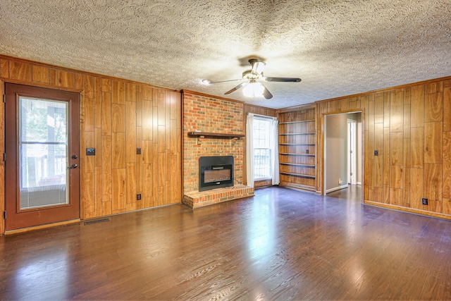 2010 Hartland Rd, Franklin, TN 37069 - unfurnished living room with wooden walls, a ceiling fan, plenty of natural light, a fireplace, and ornamental molding