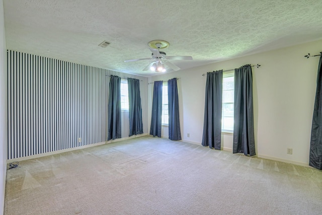 2010 Hartland Rd, Franklin, TN 37069 - empty room featuring a textured ceiling, healthy amount of natural light, carpet flooring, and a ceiling fan